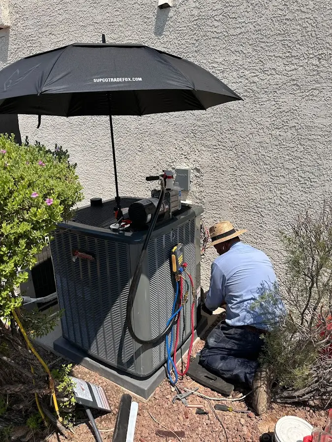 HVAC technician performing outdoor AC maintenance in Benton Harbor